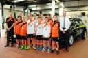 Falmouth United Rangers U13s line up at Ocean BMW alongside sales manager Matthew Wills. Picture: PHIL RUBERRY