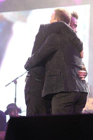 Robbie Williams and Gary Barlow hug as they prepare to perform thier new single