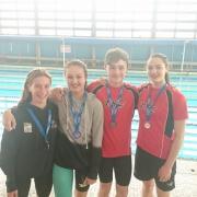 Grinners: Sophie Fussell, far right, with her fellow Teddington medal winners