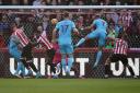 Newcastle United's Joelinton (centre-right) scores their side's first goal of the game during the Premier League match at the Brentford Community Stadium, London