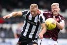 St Mirren's Curtis Main (left) and Hearts' Alex Cochrane battle for the ball during the cinch Premiership match at The SMiSA Stadium, Paisley.