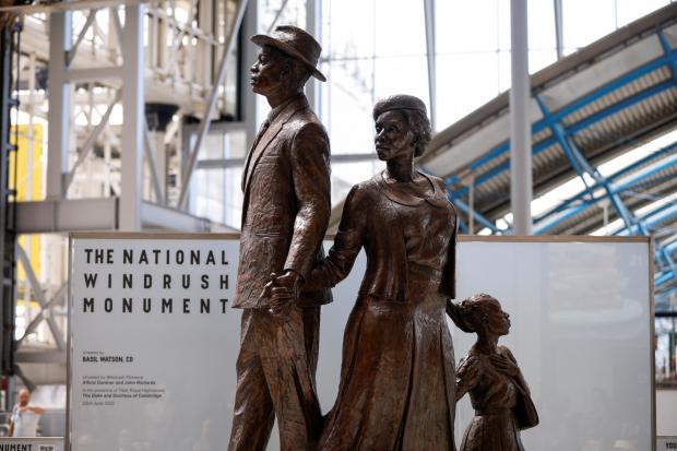 Richmond and Twickenham Times: The National Windrush Monument at Waterloo Station. The statue - of a man, woman and child in their Sunday best standing on top of suitcases - was designed by the Jamaican artist and sculptor Basil Watson