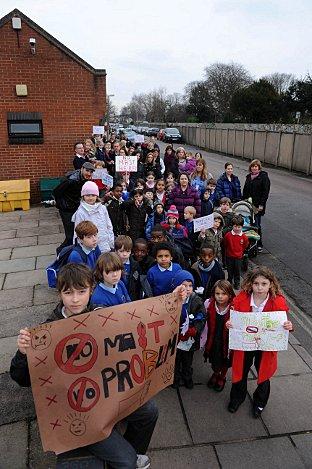 Last-ditch plea: Parents and children gathered at the site of the proposed mast, by the Avondale Road bus station in North Worple way, Mortlake, on Wednesday, to show their determination to bring the plan to a