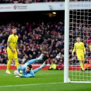 Brentford goalkeeper David Raya Martin dives in vain but fails to stop Arsenal's Emile Smith Rowe from scoring the opening goal during the Premier League match at the Emirates Stadium, London