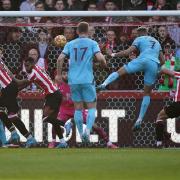 Newcastle United's Joelinton (centre-right) scores their side's first goal of the game during the Premier League match at the Brentford Community Stadium, London