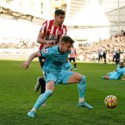 Newcastle United's Emil Krafth (right) and Brentford's Vitaly Janelt battle for the ball during the Premier League match at the Brentford Community Stadium, London