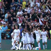 Brentford's players celebrate scoring late on to beat Watford