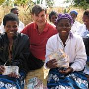 Giving back: Peter Ryan with two women he has helped