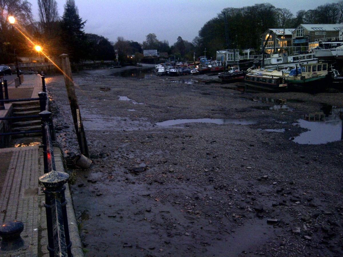 The Thames at Richmond as dusk is falling during the annual draw-off. Weirs are closed to allow for a riverbed inspection plus essential maintenance works on the lock, weirs and sluices. Photo by Yianni Papas